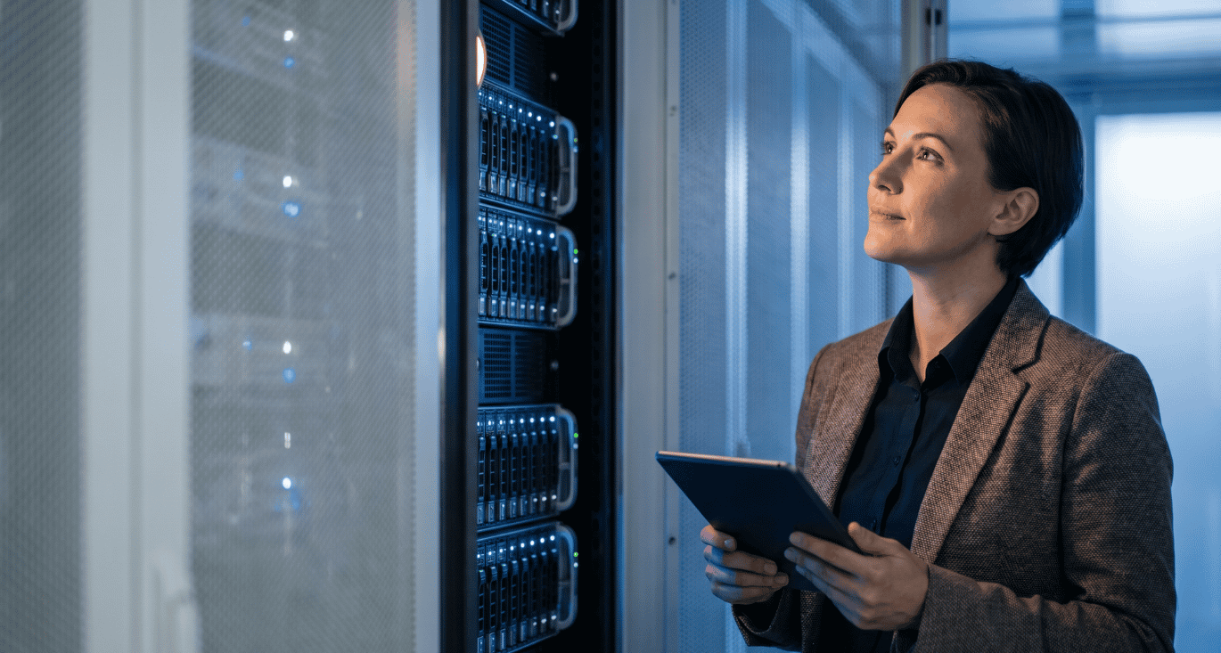 IT security manager reviewing server infrastructure on a tablet during a legacy VPN to ZTNA migration
