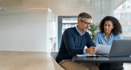 Procurement and IT leads reviewing supplier cybersecurity risk in a modern Belgian office